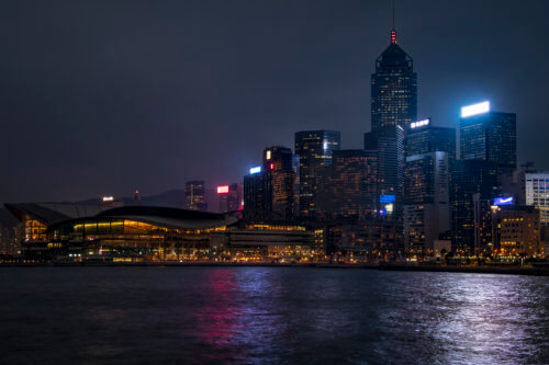 Hong Kong city by night skyscrapers, water reflection, cold, grey, Artur Rydzewski photography