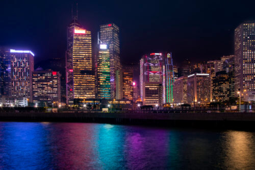 Hong Kong city by night skyscrapers, colorful water reflection, colorful, Artur Rydzewski photography