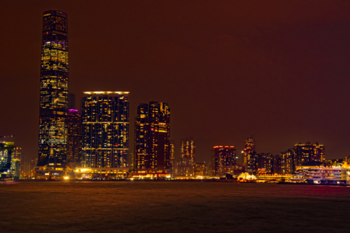 Hong Kong city by night skyscrapers, water reflection, brown red night, Artur Rydzewski photography